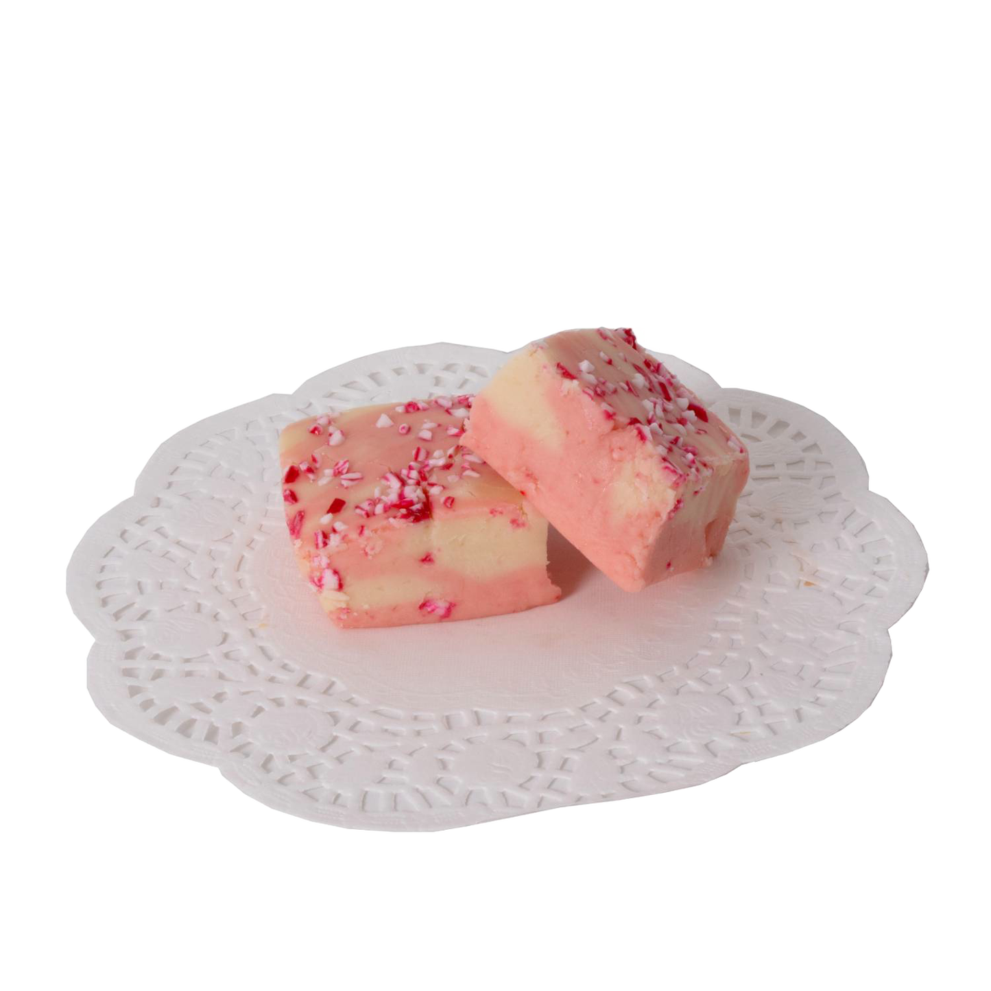 Two handcrafted peppermint fudge pieces with creamy white and pink swirls topped with crushed candy, displayed on a decorative white paper doily, part of Kitchen & Food and USA Made collections.