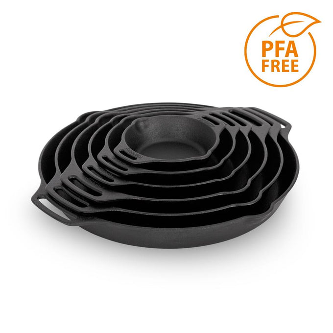 Stacked set of handcrafted cast iron fire skillets with two side handles, designed for durable use in farm, garden, kitchen, camping, cookware, and cast iron collections.