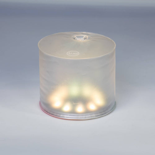Glowing inflatable LED solar light softly illuminating in a neutral setting, designed for versatile use in camping, emergency supplies, farm, garden, and outdoor lighting.