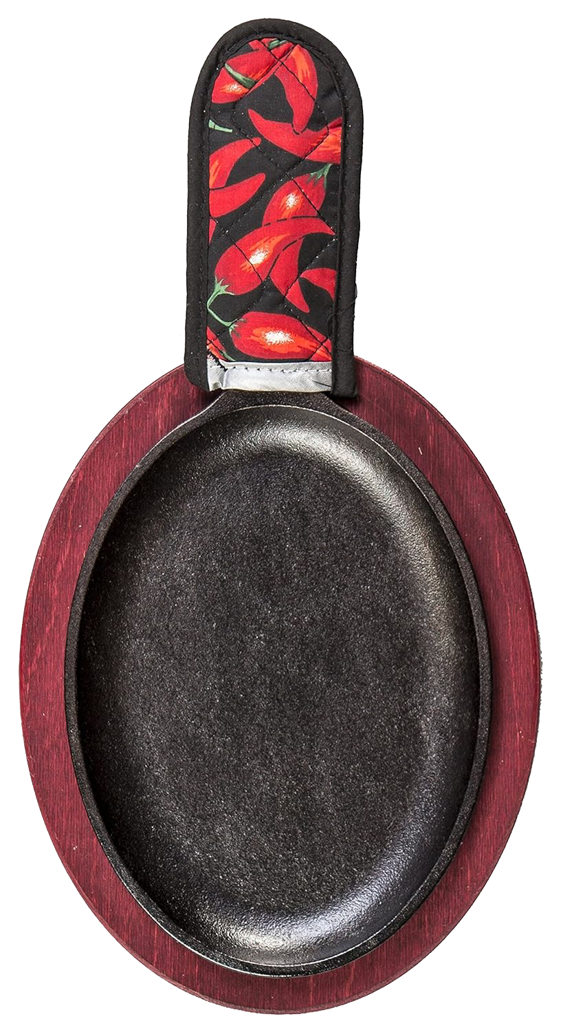 Oval cast iron griddle with a deep black cooking surface, set on a red stained wooden underliner and topped with a chili pepper patterned handle holder, ideal for camping and cookware collections.