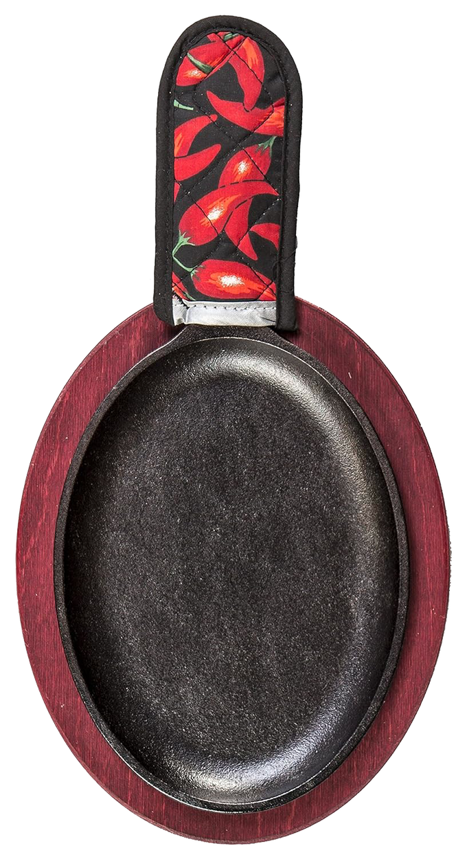 Oval cast iron griddle with a deep black cooking surface, set on a red stained wooden underliner and topped with a chili pepper patterned handle holder, ideal for camping and cookware collections.
