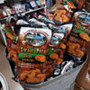 Bags of handcrafted sweet potato chips with sea salt, gluten free and made in USA, displayed in a rustic metal tub within Kitchen & Food and Snacks collections.