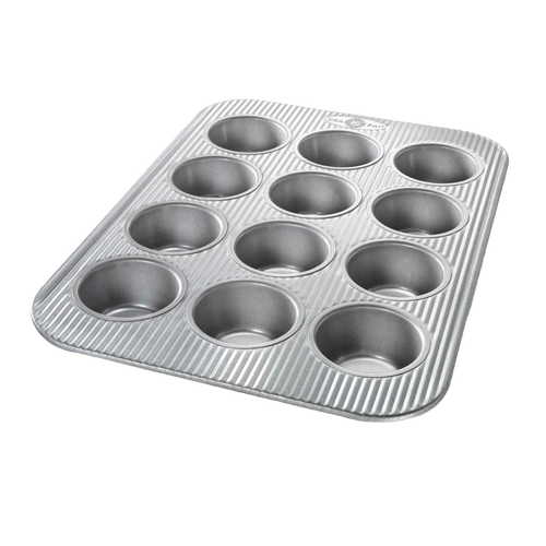 Durable 12-cup muffin pan with fluted surface and patented Americoat Plus nonstick coating, crafted for Kitchen & Food, Cookware, Baking Supplies, and USA Made collections.