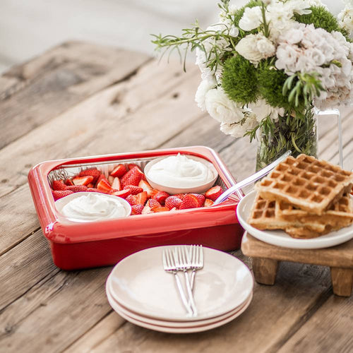 Red Fancy Panz foil pan cover enclosing fresh sliced strawberries with two dollops of whipped cream, set on a rustic wood table with stacked plates, forks, waffles, and a floral vase, ideal for Kitchen & Food, Kitchen Gadgets, Storage and Serving, USA Made, and Best Sellers collections.