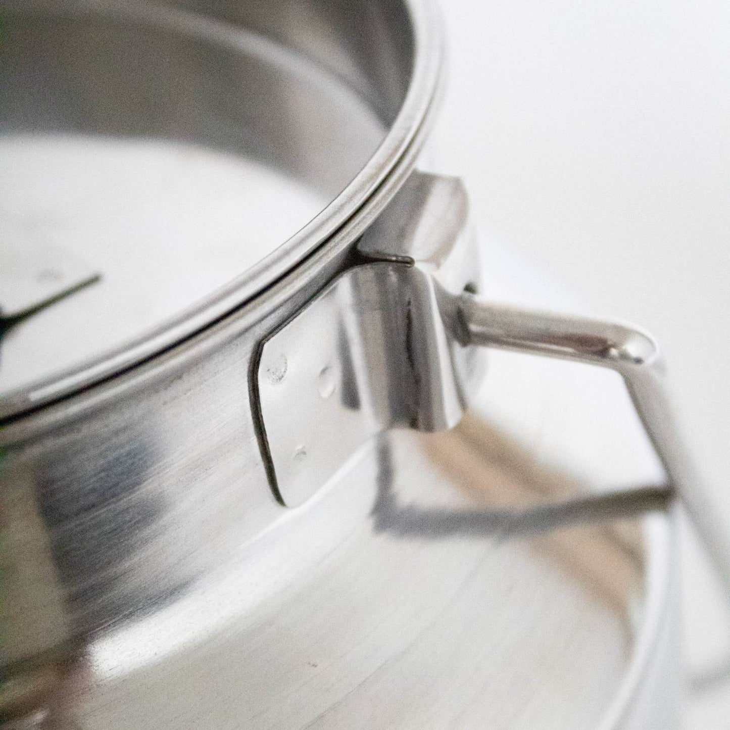 Close-up view of a seamless 304 grade stainless steel milk can handle with a polished finish, crafted for easy cleaning and durability in farm and animal care settings.
