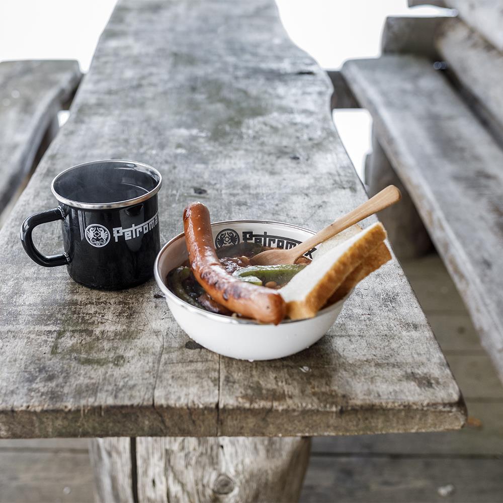 White enamel bowl with black rim holding sausage, green beans, and two slices of bread, accompanied by a black enamel mug on a rustic wooden surface, suitable for Farm, Garden & Tool, Kitchen & Food, Camping, Dinnerware, Best Sellers, and Promo Eligible collections.