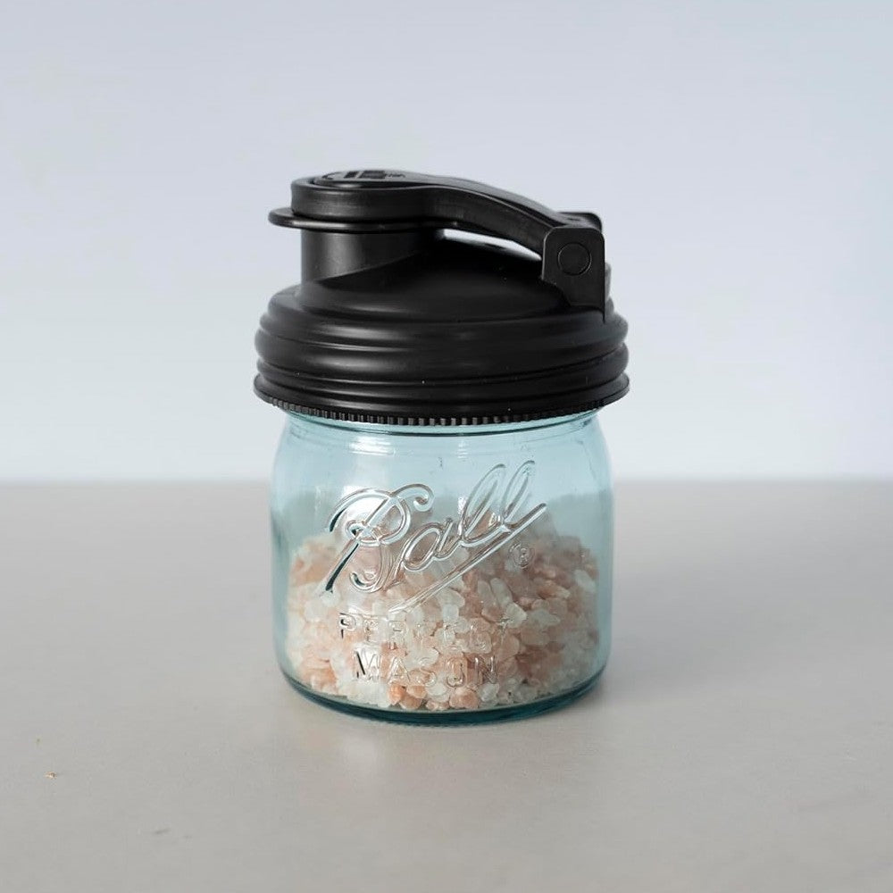 Small clear Ball jar filled with pink salt and fitted with a black pour lid featuring a flip-top spout and carry loop, crafted from durable no-break plastic, ideal for Kitchen & Food and USA Made collections.