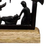 Handcrafted cast iron nativity scene featuring the Holy Family silhouette on a natural wooden base, designed for Holiday Decor, Home & Decor, Best Sellers, and Promo Eligible collections.