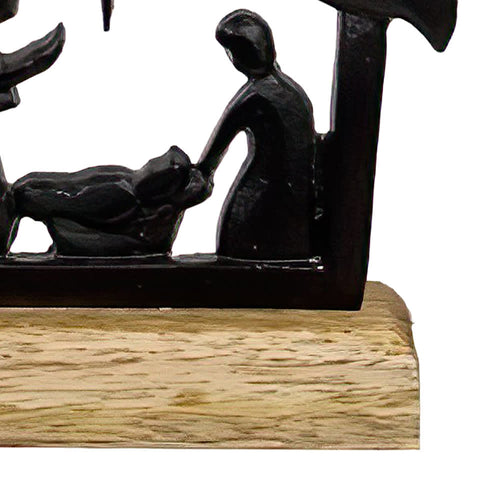 Handcrafted cast iron nativity scene featuring the Holy Family silhouette on a natural wooden base, designed for Holiday Decor, Home & Decor, Best Sellers, and Promo Eligible collections.