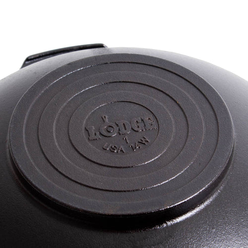 Close-up of the base of a cast iron wok featuring a stamped logo and size, highlighting durable construction and handcrafted quality, ideal for Kitchen & Food, Cast Iron, USA Made, and Best Sellers collections.