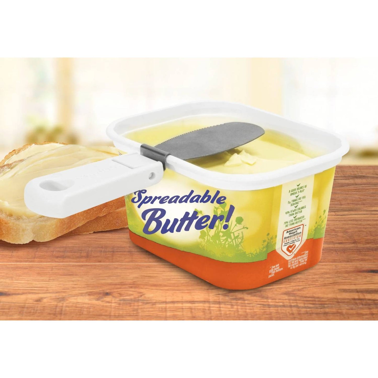 Foldable butter knife with a collapsible white handle snapped onto a rectangular butter tub for easy spreading and storage, perfect for Kitchen & Food, Kitchen Gadgets, and Best Sellers collections.