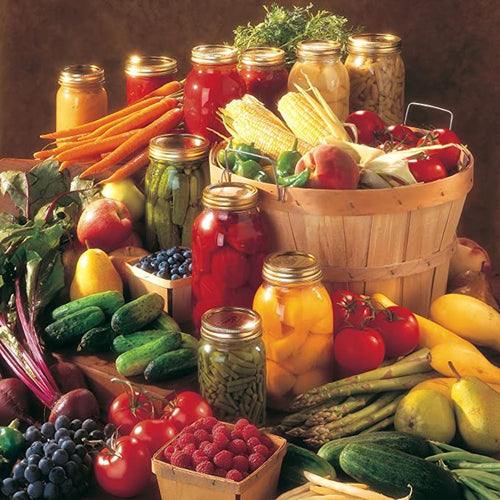 Assortment of fresh fruits and vegetables with glass jars of preserved produce arranged beside a rustic wooden basket, highlighting food preservation in kitchen and canning collections.