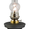 Rayo Small But Mighty Oil Lamp with a bright flame, featuring a black base and clear glass chimney, handcrafted for farm, garden, emergency, and table lighting collections.
