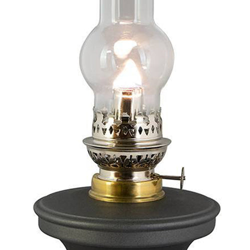 Rayo Small But Mighty Oil Lamp with a bright flame, featuring a black base and clear glass chimney, handcrafted for farm, garden, emergency, and table lighting collections.