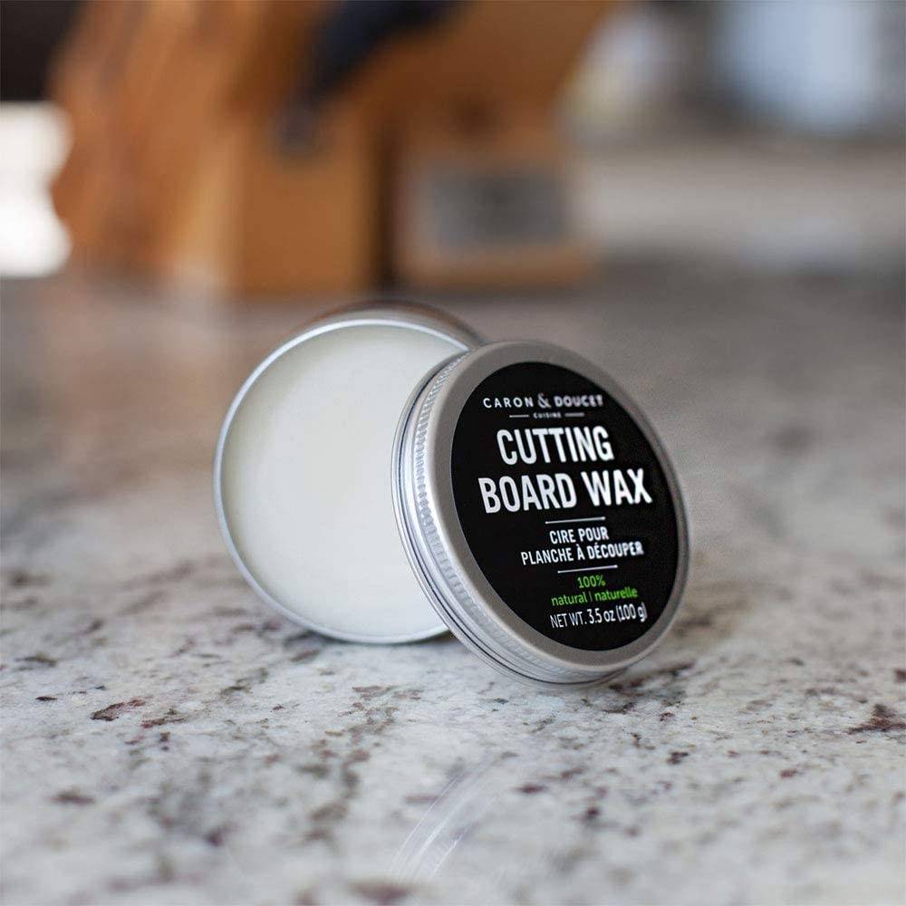 Open tin of plant-based cutting board wax conditioner with black label and silver lid resting on marble countertop, ideal for Kitchen & Food and Food Prep collections.