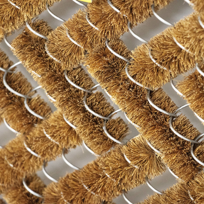 Close-up of a handcrafted bootscraper featuring densely packed natural coconut fiber bristles woven around sturdy wire frames, part of Home & Decor, Home Textiles, Best Sellers, and Promo Eligible collections.