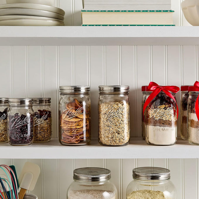 Set of three wide mouth glass jars with stainless steel airtight lids storing dried fruits, oats, and baking mixes, displayed on a white kitchen shelf in Kitchen & Food and Storage collections.