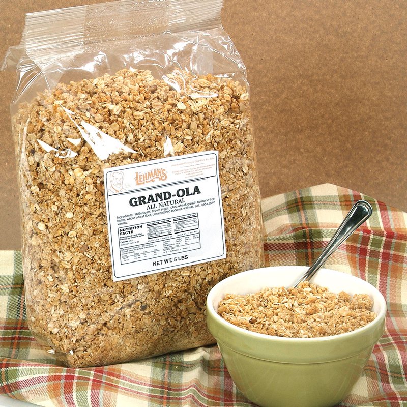 Clear plastic bag of handcrafted Amish made all-natural granola beside a green bowl filled with crunchy granola and spoon, set on plaid cloth in Kitchen & Food, Snacks and Sweets, Pantry collections.