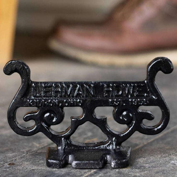 Glossy black cast aluminum boot scraper with vintage scrollwork design, handcrafted by Amish artisans in the USA, perfect for Home & Decor and Household Helpers collections.