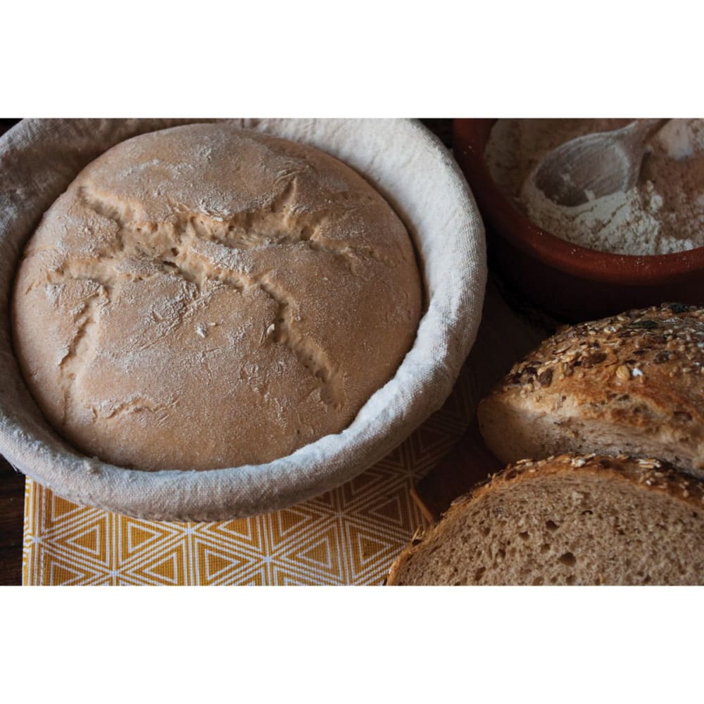 Handcrafted rattan proofing basket with removable cloth liner dusted with flour, supporting even dough rising, ideal for Kitchen & Food, Baking Supplies, and Bread Making collections.
