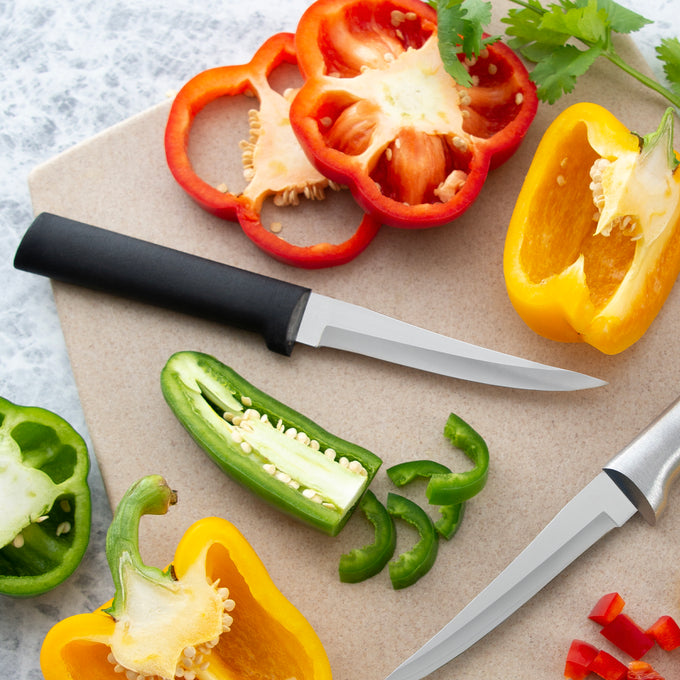 Handcrafted paring knife with a sleek black handle and high carbon surgical stainless steel blade slicing colorful bell peppers on a cutting board, ideal for kitchen knives and food prep in Farm, Garden & Tool and USA Made collections.
