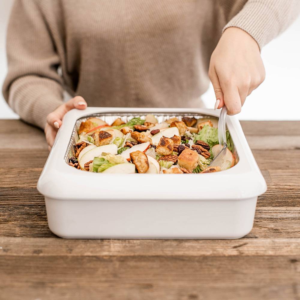 Person serving fresh salad from a white rectangular ceramic dish on a wooden table, ideal for Kitchen & Food, Kitchen Accessories, Storage and Serving, USA Made, and Best Sellers collections.