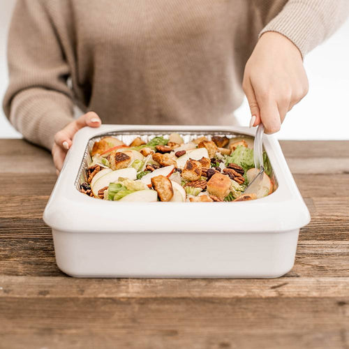 Person serving fresh salad from a white rectangular ceramic dish on a wooden table, ideal for Kitchen & Food, Kitchen Accessories, Storage and Serving, USA Made, and Best Sellers collections.