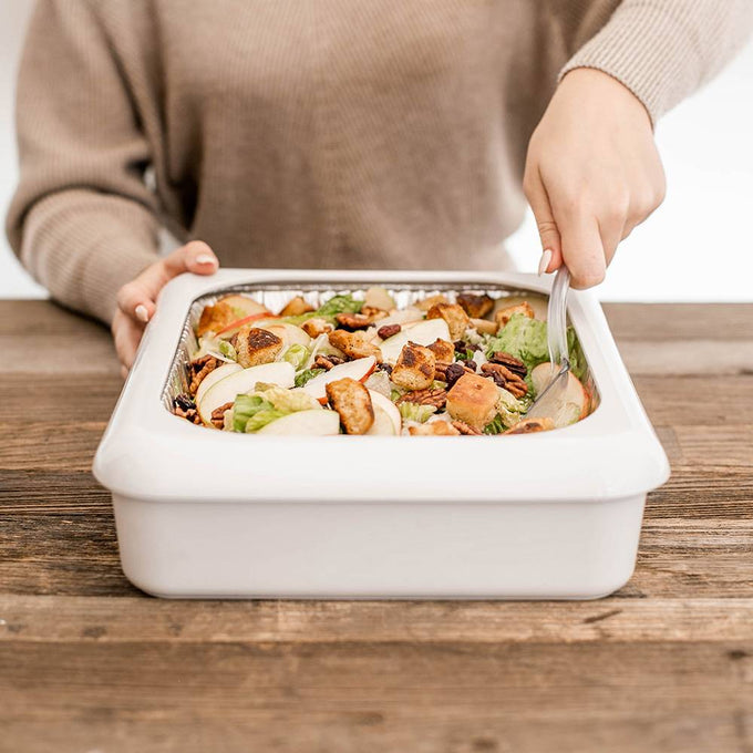 Person serving fresh salad from a white rectangular ceramic dish on a wooden table, ideal for Kitchen & Food, Kitchen Accessories, Storage and Serving, USA Made, and Best Sellers collections.