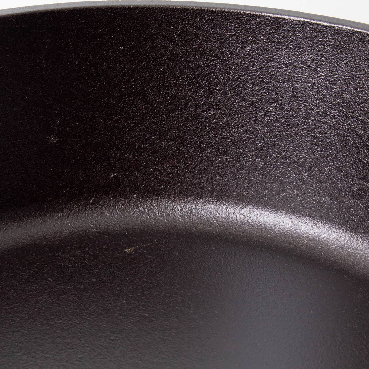 Close-up of the smooth, seasoned surface of a handcrafted cast iron camp Dutch oven, showcasing durable construction ideal for Farm, Garden & Tool, Camping, and Cookware collections.