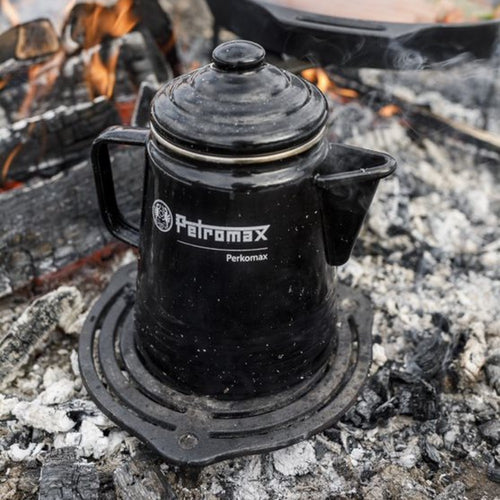 Black enameled steel percolator with lid and spout, brewing coffee or tea over glowing campfire embers, featured for Farm, Garden & Tool, Camping, Kitchen & Food, Brewing Coffee and Tea, and Best Sellers collections.