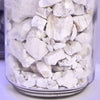 Close-up of rough white calcium carbide chunks stored in a clear container, handcrafted for use in lamps and lighting, parts and accessories, and lamp and lantern fuel collections.