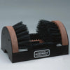 Heavy-duty shoe cleaner with dense nylon bristles on a steel frame and wooden accents, designed to remove mud and dirt from soles and sides; USA made, featured in Household Cleaning and Home & Decor collections.