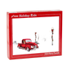 Red vintage pickup truck with a dog in the cab driving through a snowy scene with decorated lampposts and benches, captured on a festive holiday puzzle box for Toys, Books & Games and Puzzles collections.