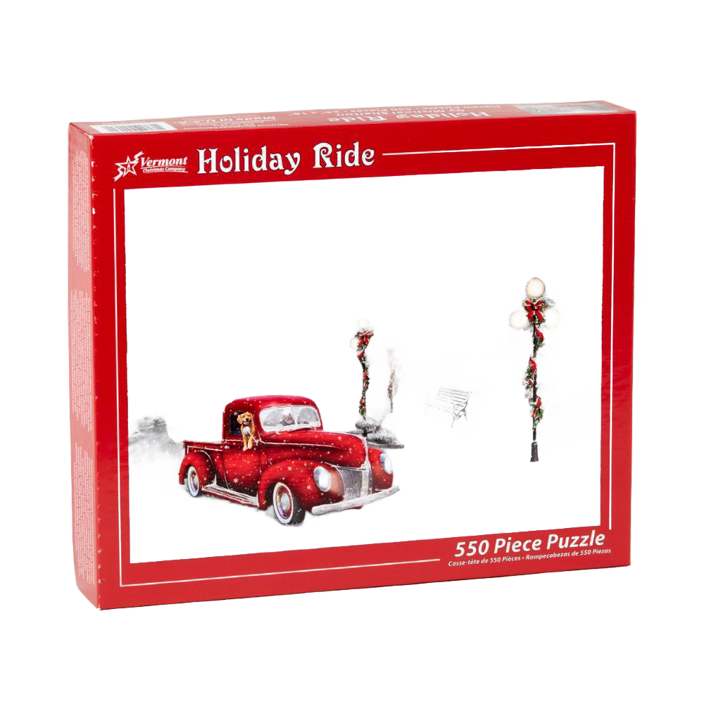 Red vintage pickup truck with a dog in the cab driving through a snowy scene with decorated lampposts and benches, captured on a festive holiday puzzle box for Toys, Books & Games and Puzzles collections.