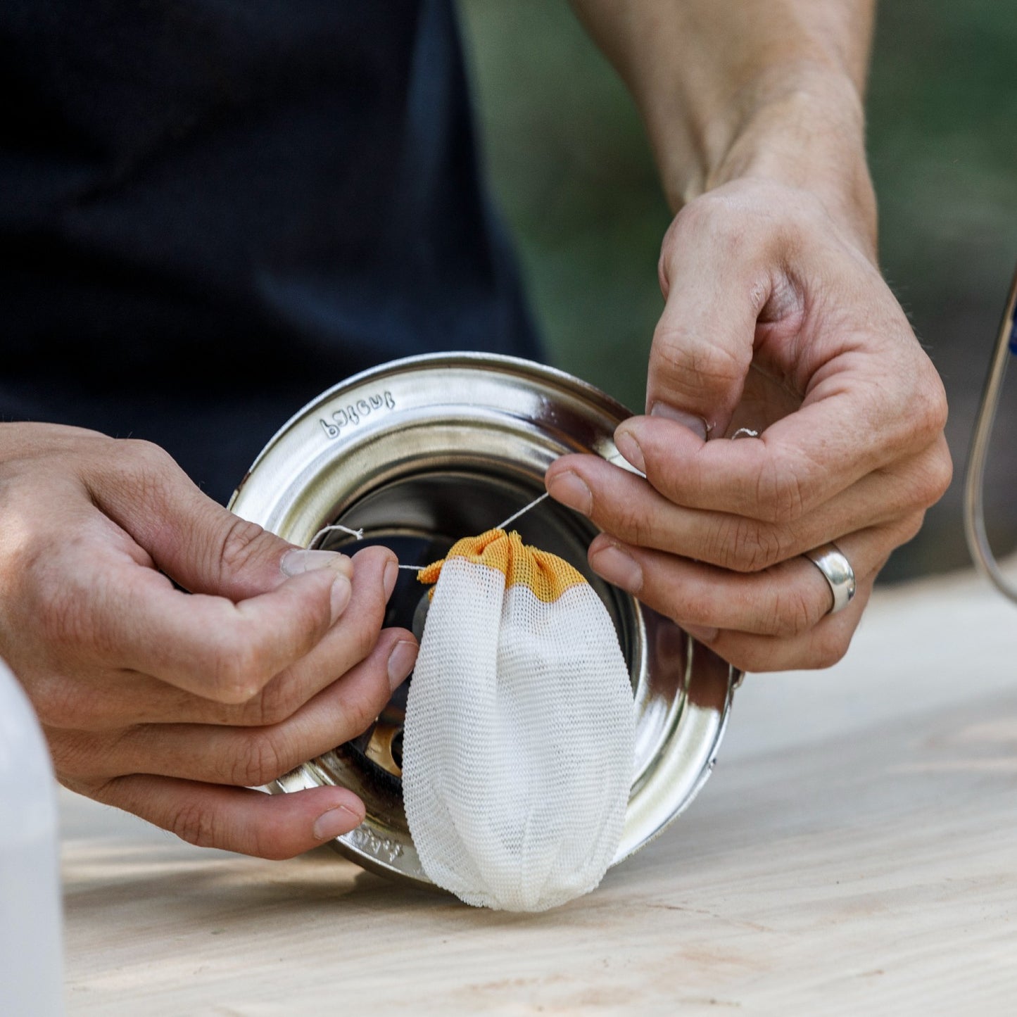 Hands installing a white and yellow rounded replacement mantle on a metal high-pressure lamp part, featured in Lamps & Lighting, Parts and Accessories, Wicks and Mantles, Best Sellers, and Promo Eligible collections.