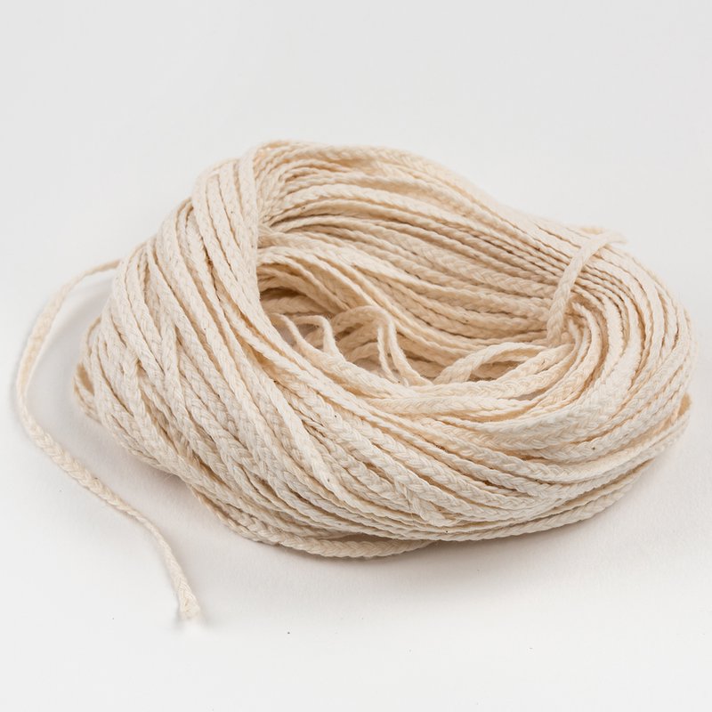 Coiled natural flat-braid wick made with 15 plies, ideal for use in candle making, suited for Lamps & Lighting, Candles and Candlemaking, Candlemaking Supplies, Best Sellers, and Promo Eligible collections.