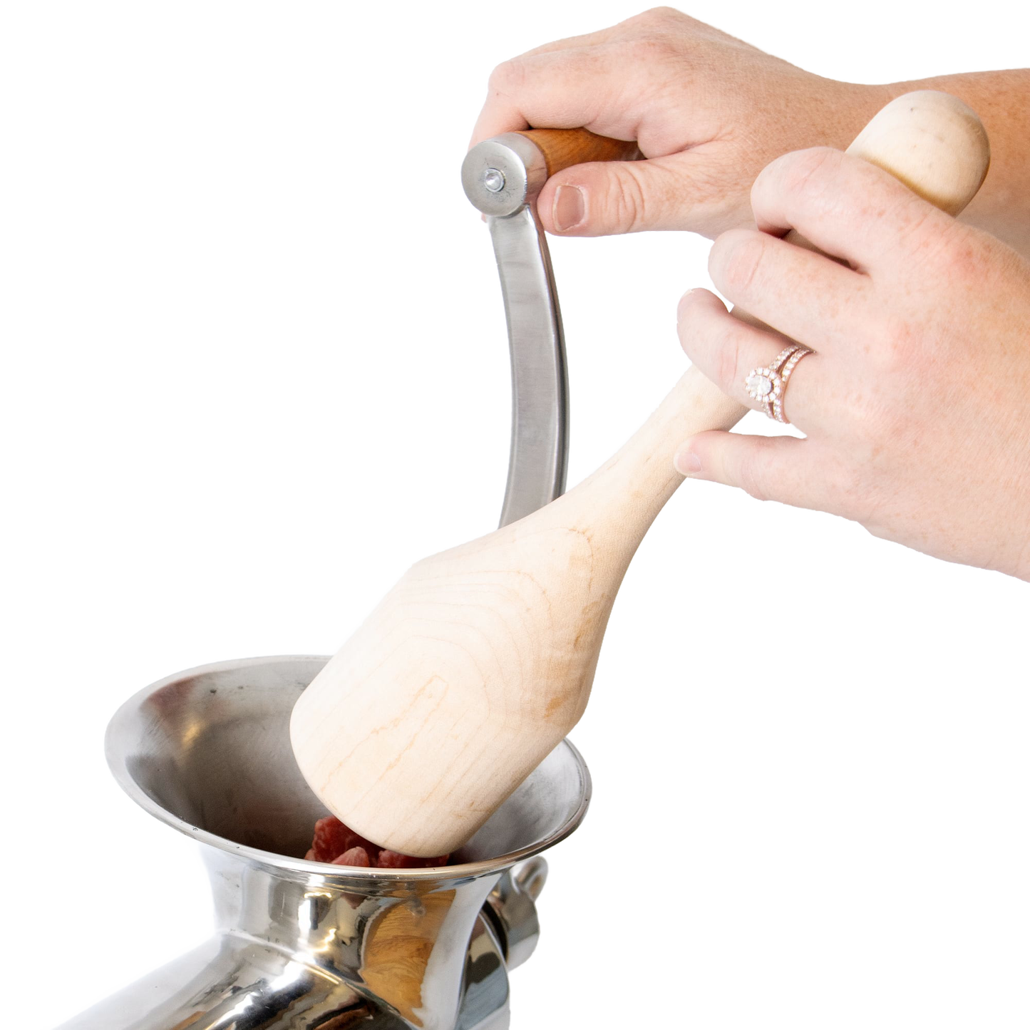 Hands using a smoothly sanded hardwood stumper to safely feed meat into a metal grinder, showcasing handcrafted Amish Made quality in Kitchen & Food and Butchering Supplies collections.