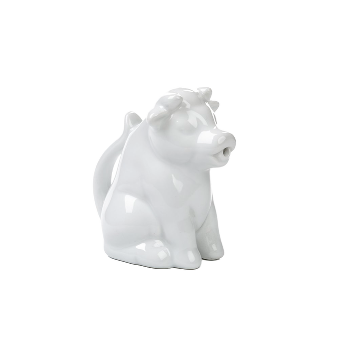 Glossy white porcelain creamer shaped like a sitting cow with a tail handle and pouring-spout mouth, handcrafted and perfect for Kitchen & Food, Brewing Coffee and Tea, Dinnerware collections.