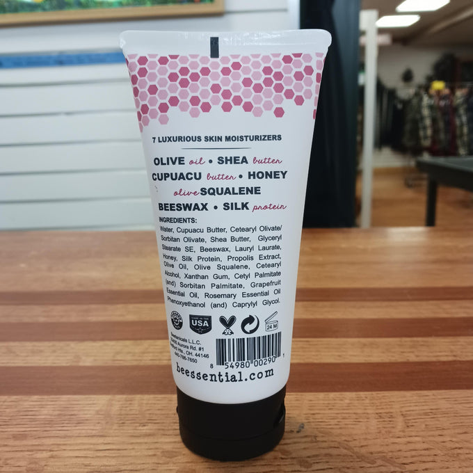 Back view of a 6 fl oz tube of Beessential Hand and Body Cream highlighting natural moisturizers like olive oil, shea butter, honey, beeswax, and silk protein, handcrafted in USA, featured in Health & Wellness, Balms, Creams and Lotions, USA Made, Best Sellers, Promo Eligible, and Sale collections.