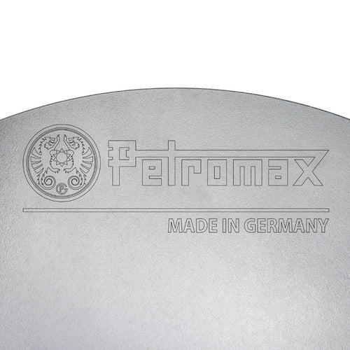 Close-up of a steel cooking surface embossed with a brand logo and "Made in Germany" text, highlighting quality craftsmanship for outdoor use in Farm, Garden & Tool, Camping, Best Sellers, and Promo Eligible collections.
