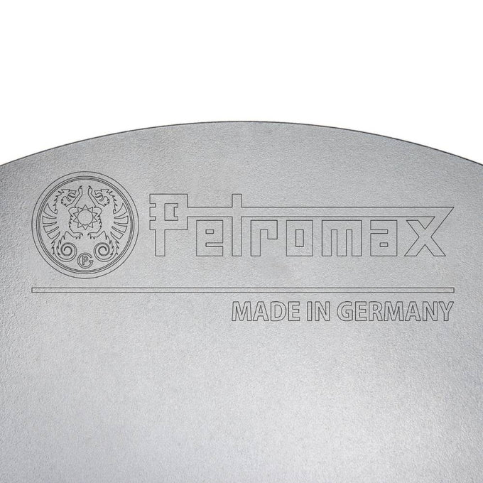 Close-up of a steel cooking surface embossed with a brand logo and "Made in Germany" text, highlighting quality craftsmanship for outdoor use in Farm, Garden & Tool, Camping, Best Sellers, and Promo Eligible collections.