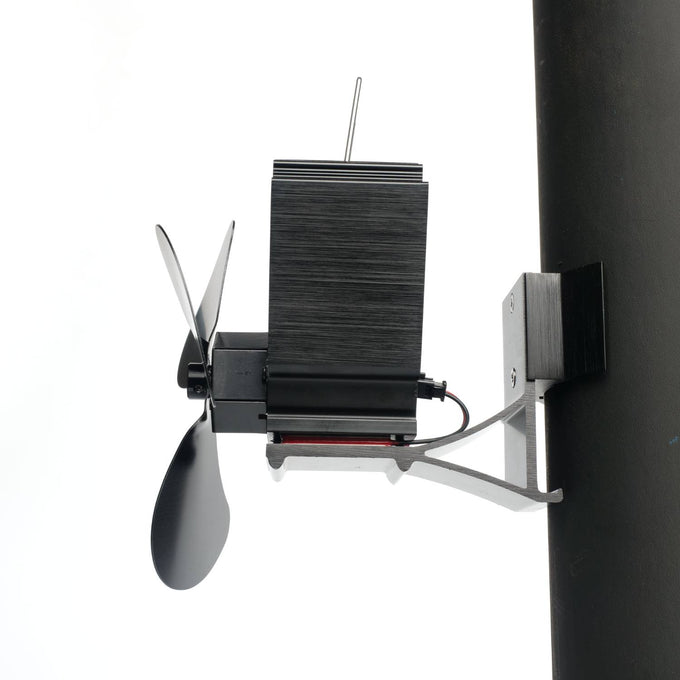 Black heat-driven magnetic stove fan with three blades mounted on a vertical pipe, designed to improve warm air flow, featured in Stoves, Hearth Accessories, Best Sellers, and Promo Eligible collections.