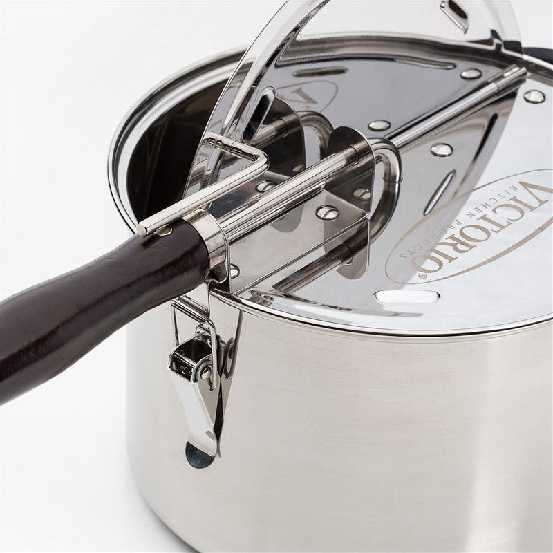 Close-up of a durable stainless steel stovetop popcorn popper with a dark wooden handle and a gearless cable mechanism, featured in Kitchen & Food, Cookware, Pots and Pans, and Popcorn collections.