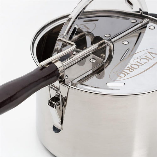 Close-up of a durable stainless steel stovetop popcorn popper with a dark wooden handle and a gearless cable mechanism, featured in Kitchen & Food, Cookware, Pots and Pans, and Popcorn collections.