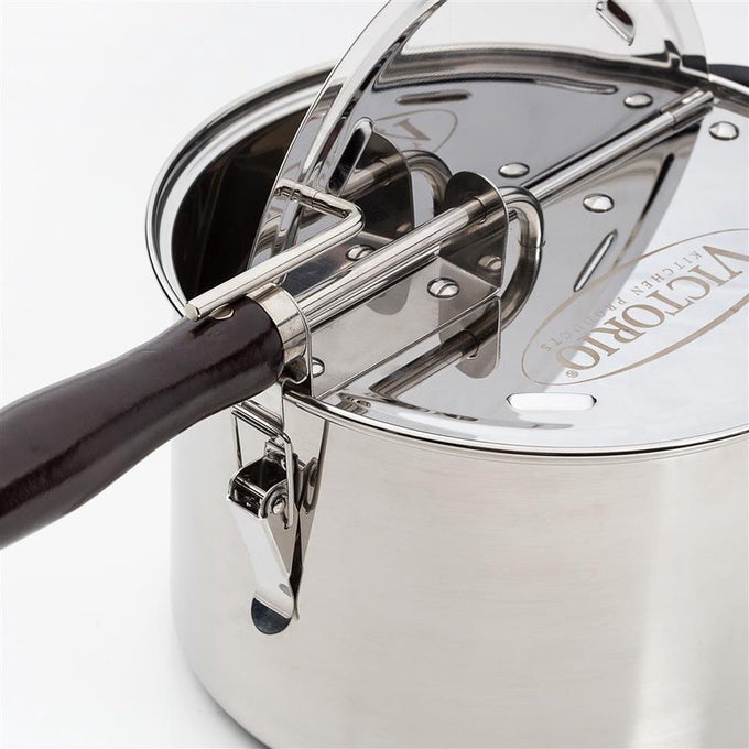 Close-up of a durable stainless steel stovetop popcorn popper with a dark wooden handle and a gearless cable mechanism, featured in Kitchen & Food, Cookware, Pots and Pans, and Popcorn collections.