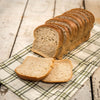 Handcrafted Amish-style bread with thick, soft slices, made in the USA, displayed on a plaid cloth, ideal for Kitchen & Food, Snacks and Sweets, and Best Sellers collections.
