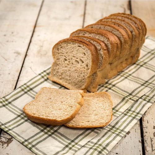 Handcrafted Amish-style bread with thick, soft slices, made in the USA, displayed on a plaid cloth, ideal for Kitchen & Food, Snacks and Sweets, and Best Sellers collections.