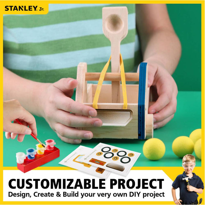 Child holding a wooden truck catapult with yellow rubber bands, paint set with four colors, wheels stickers, and four yellow foam balls, a hands-on DIY toy in Toys, Books & Games and Arts and Crafts collections.