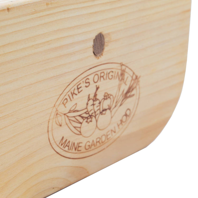 Close-up of smooth wooden end panel with engraved Pike’s Original Maine Garden Hod logo featuring vegetables, part of Farm, Garden & Tool, Garden Accessories, USA Made, and Best Sellers collections.
