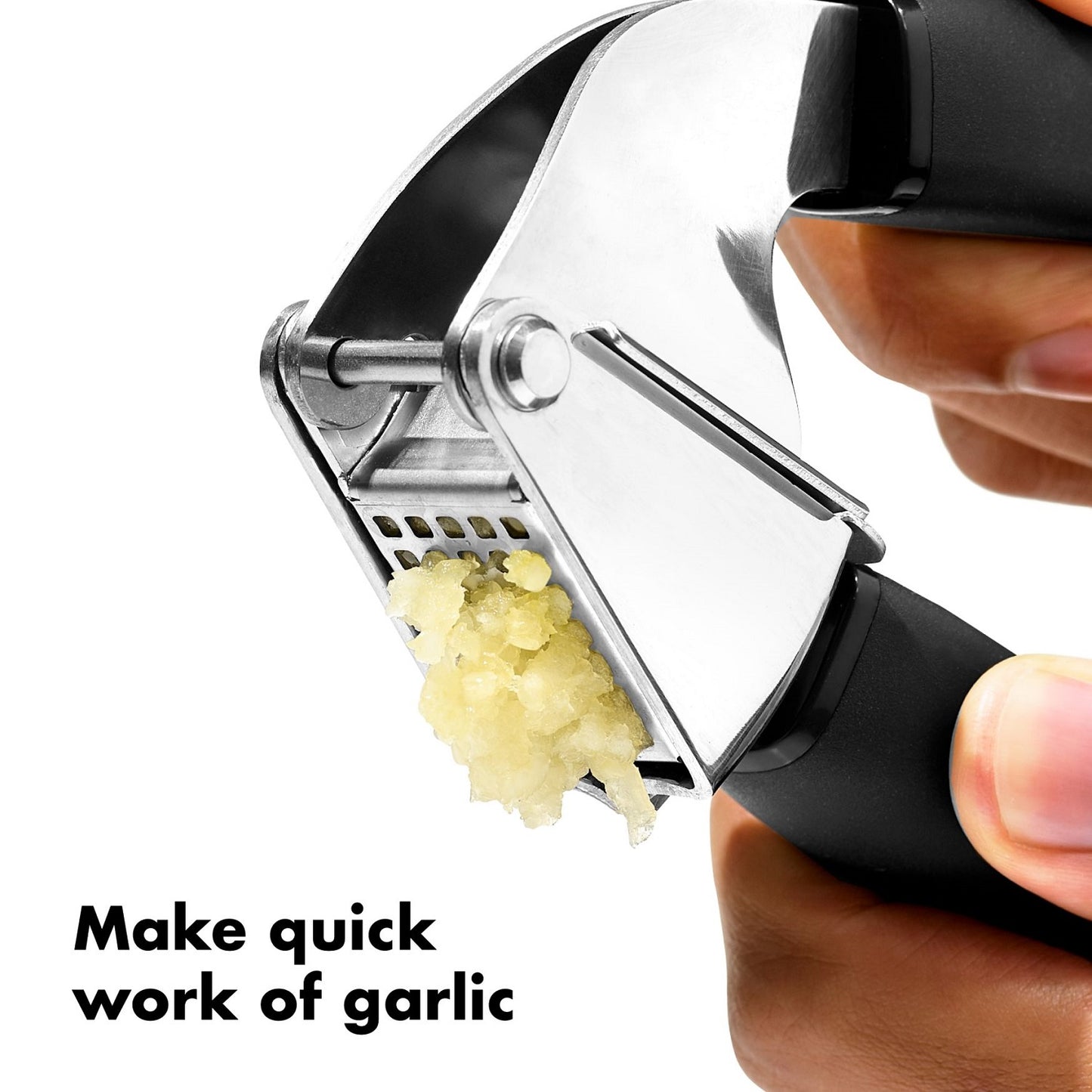 Close-up of a stainless steel garlic press with soft, non-slip black handles crushing fresh garlic, designed for comfortable use in Kitchen & Food and Cooking and Baking Helpers collections.